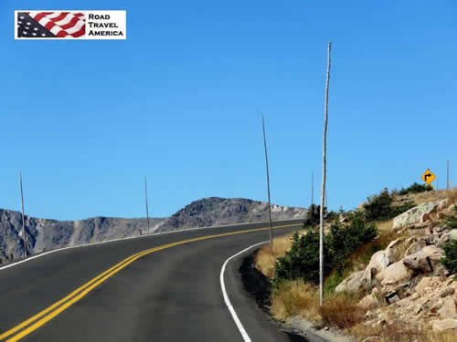 Steep curves and tall snow poles on Trail Ridge Road before the start of winter
