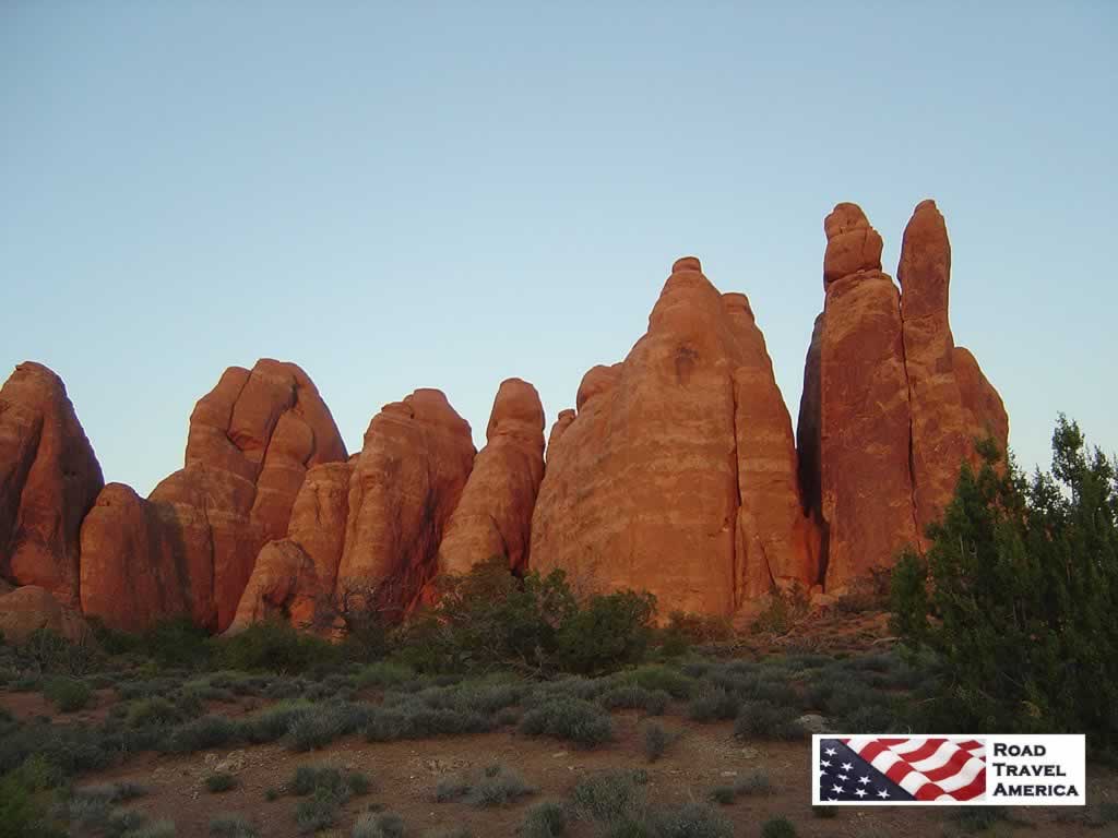 Sunset casting brilliant, orange tones on the rocks at Arches National Park Sunset casting brilliant, orange tones on the rocks at Arches National Park